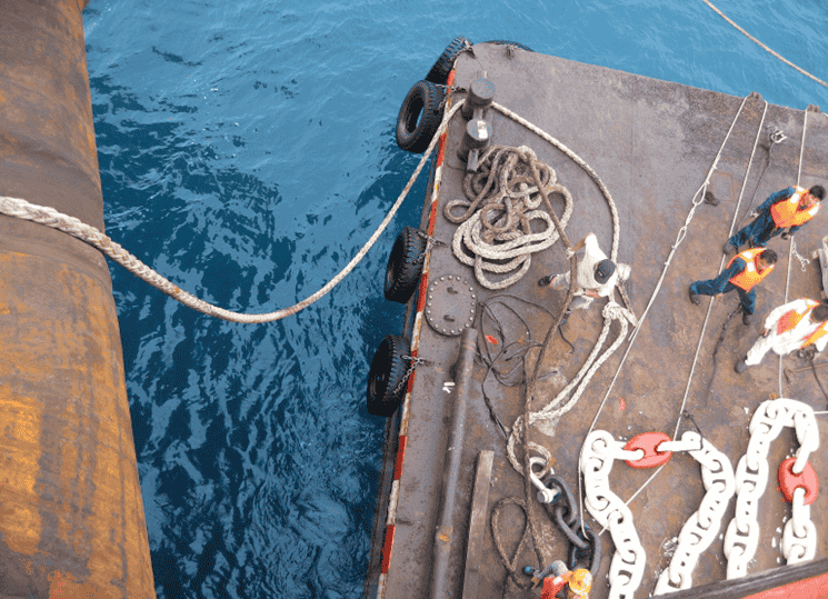 Barge positioned next to a mother vessel for installation